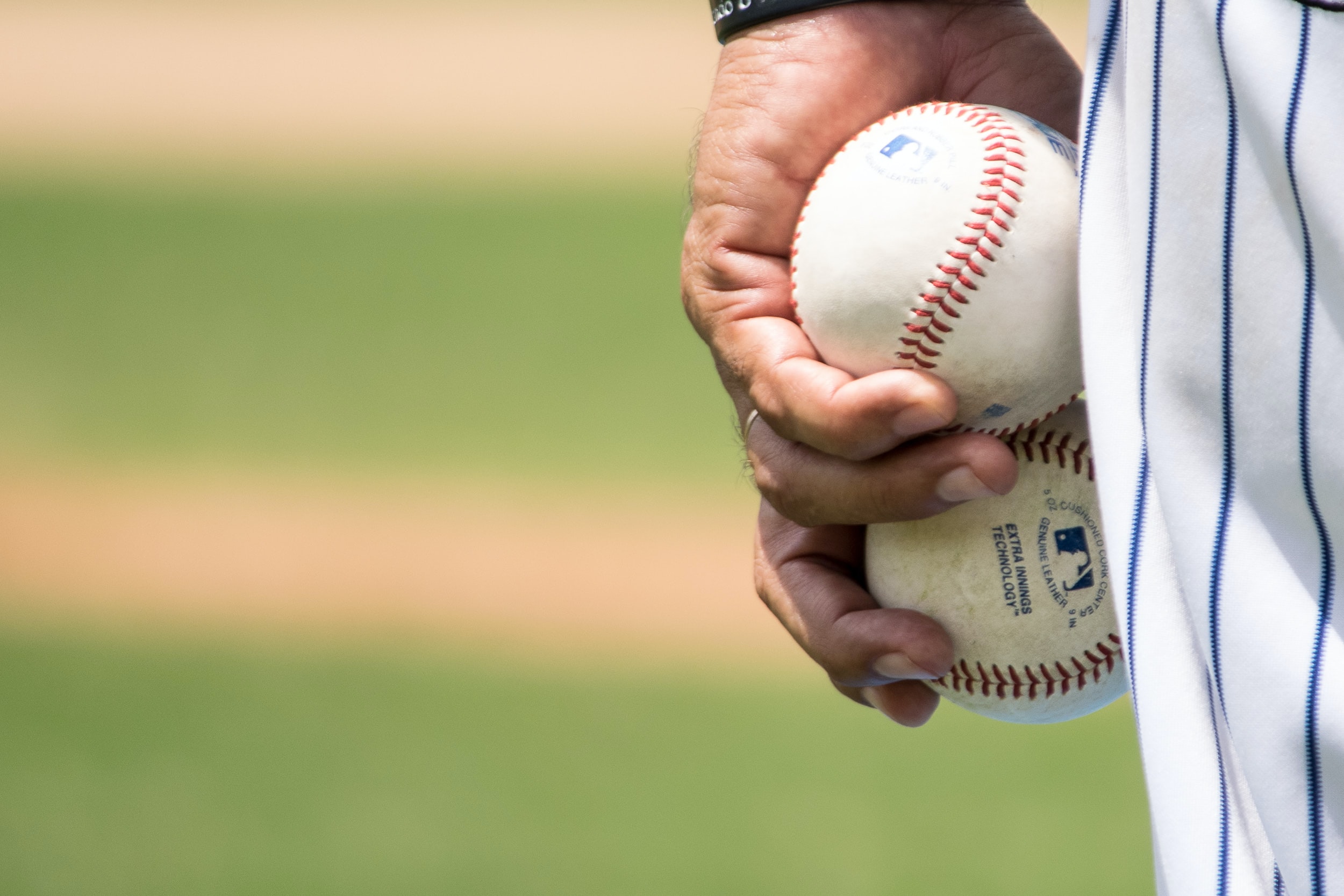 Person holding baseballs